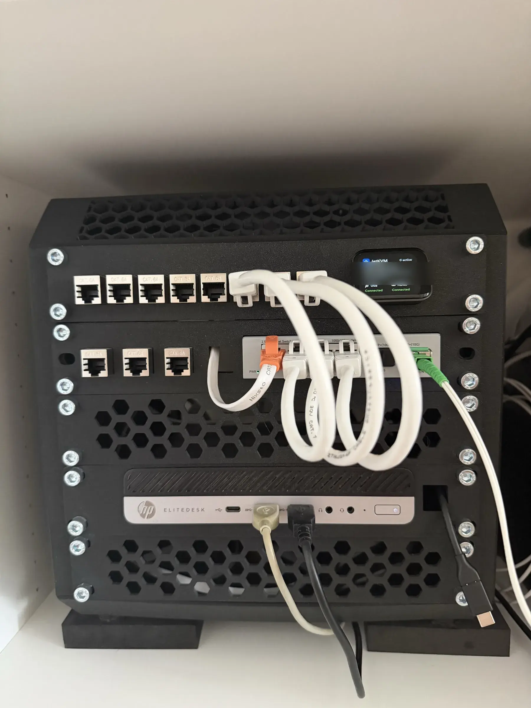Rear view of the homelab rack: router, unmanaged switch and HP EliteDesk mini PC wired together